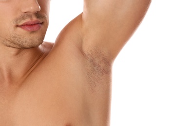 Photo of Young man showing hairy armpit on white background, closeup. Epilation procedure