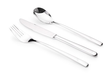 Photo of Shiny silver fork, knife and spoon isolated on white. Luxury cutlery set