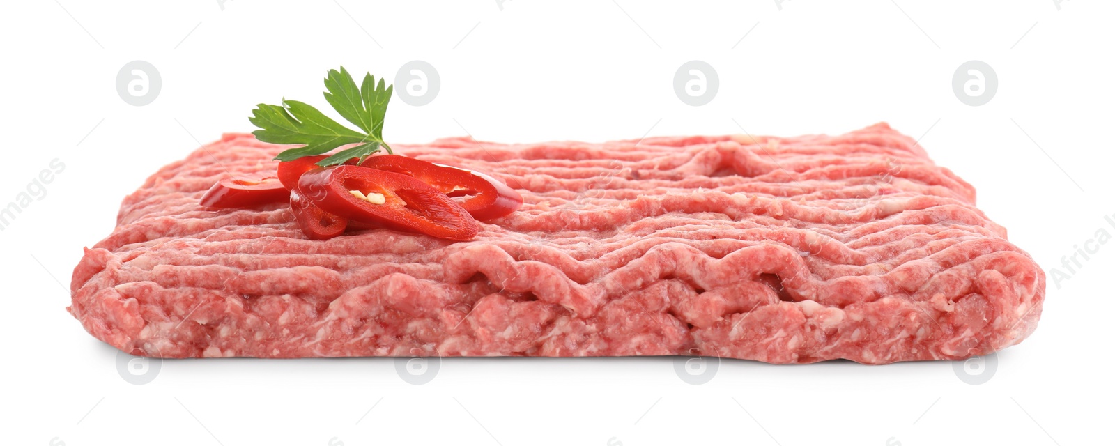 Photo of Raw ground meat, chili pepper and parsley isolated on white