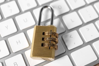 Photo of Cyber security. Padlock on keyboard, closeup view