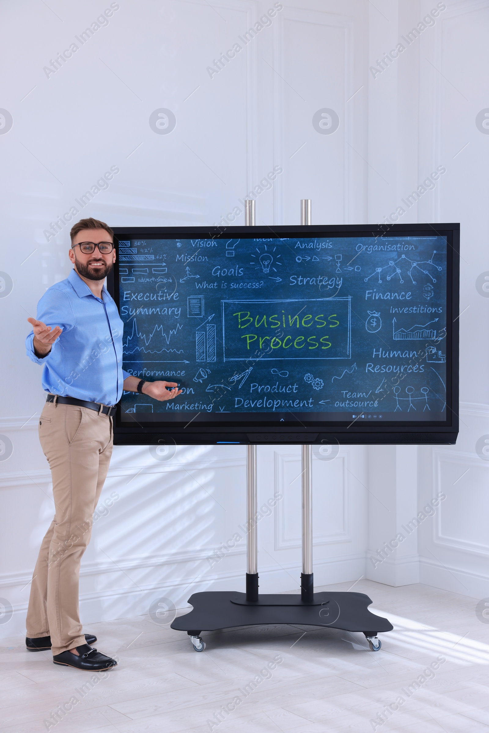 Photo of Business trainer using interactive board in meeting room