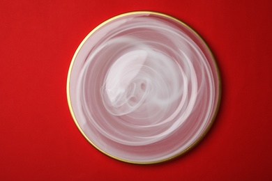 Clean empty plate on color background, top view