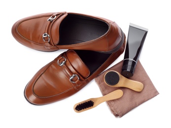 Stylish footwear and shoe care products on white background, top view