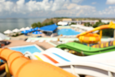 Photo of Different colorful slides in water park, blurred view