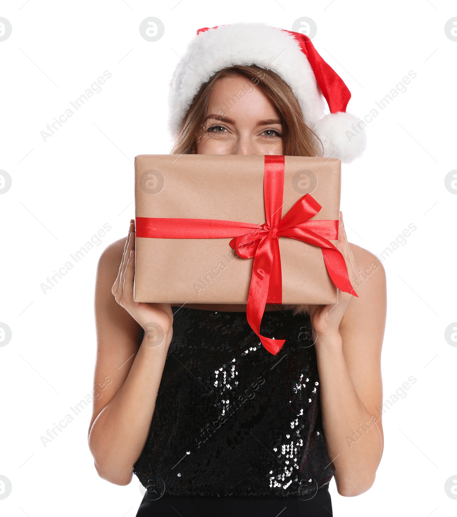 Photo of Happy young woman in Santa hat with gift box on white background. Christmas celebration