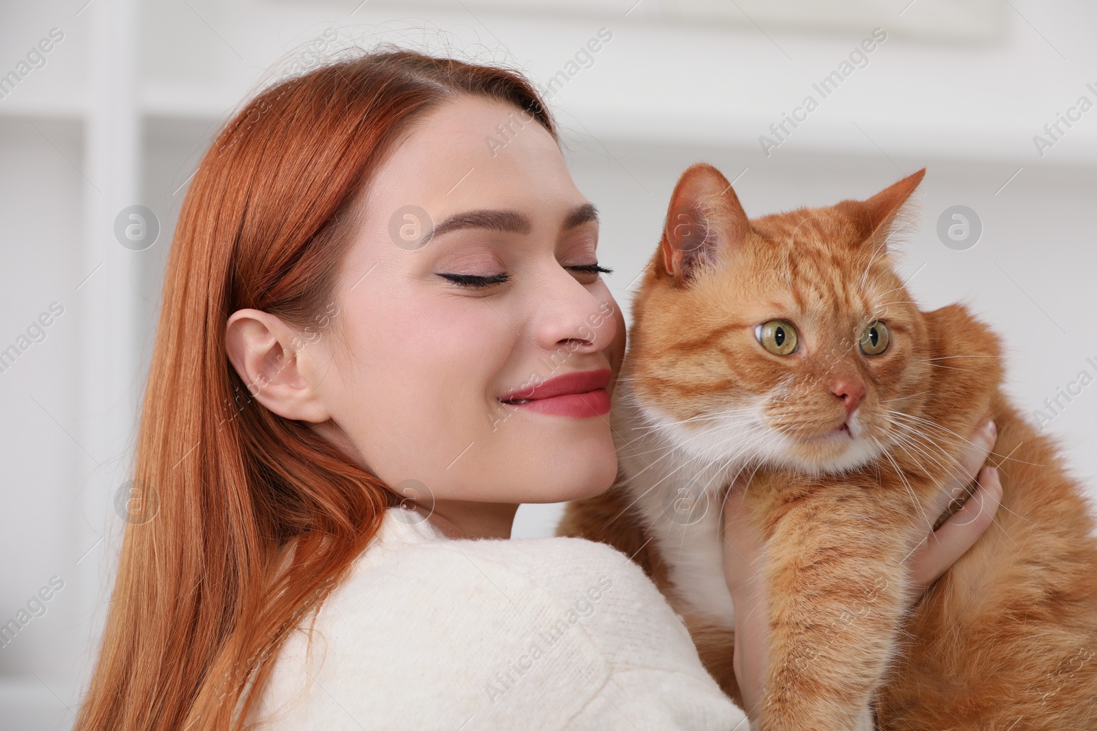 Photo of Woman with her cute cat at home