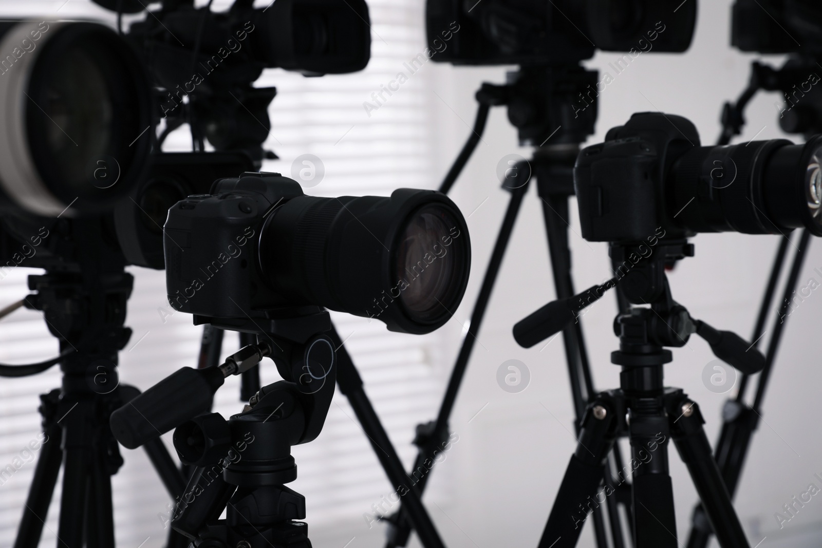 Photo of Modern video cameras indoors, closeup. Professional media equipment for broadcasting event