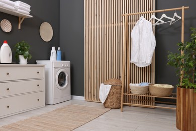 Photo of Laundry room interior with washing machine and furniture