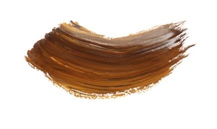 Photo of Abstract brushstroke of brown paint isolated on white