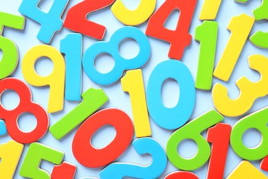 Photo of Colorful numbers on light blue background, flat lay