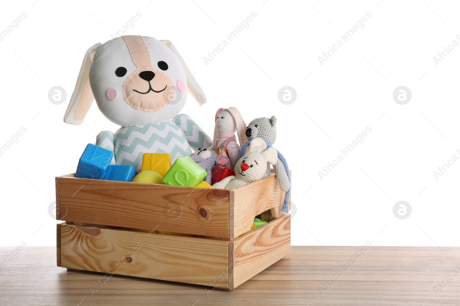 Photo of Set of different toys on wooden table against white background. Space for text