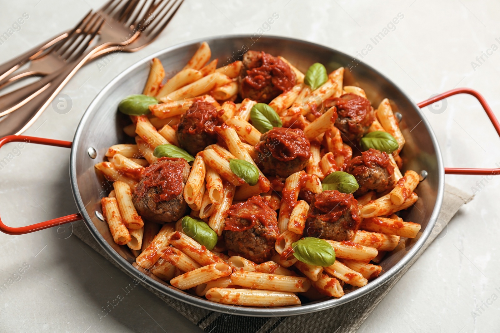 Photo of Delicious pasta with meatballs and tomato sauce on grey background