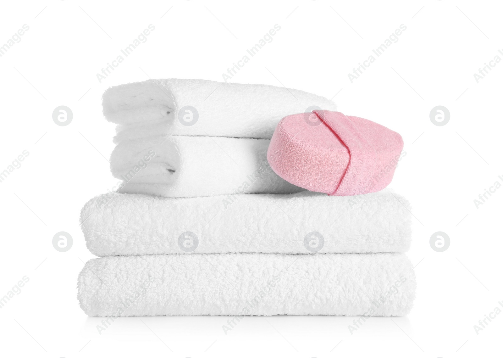 Photo of Stack of clean soft towels and sponge on white background