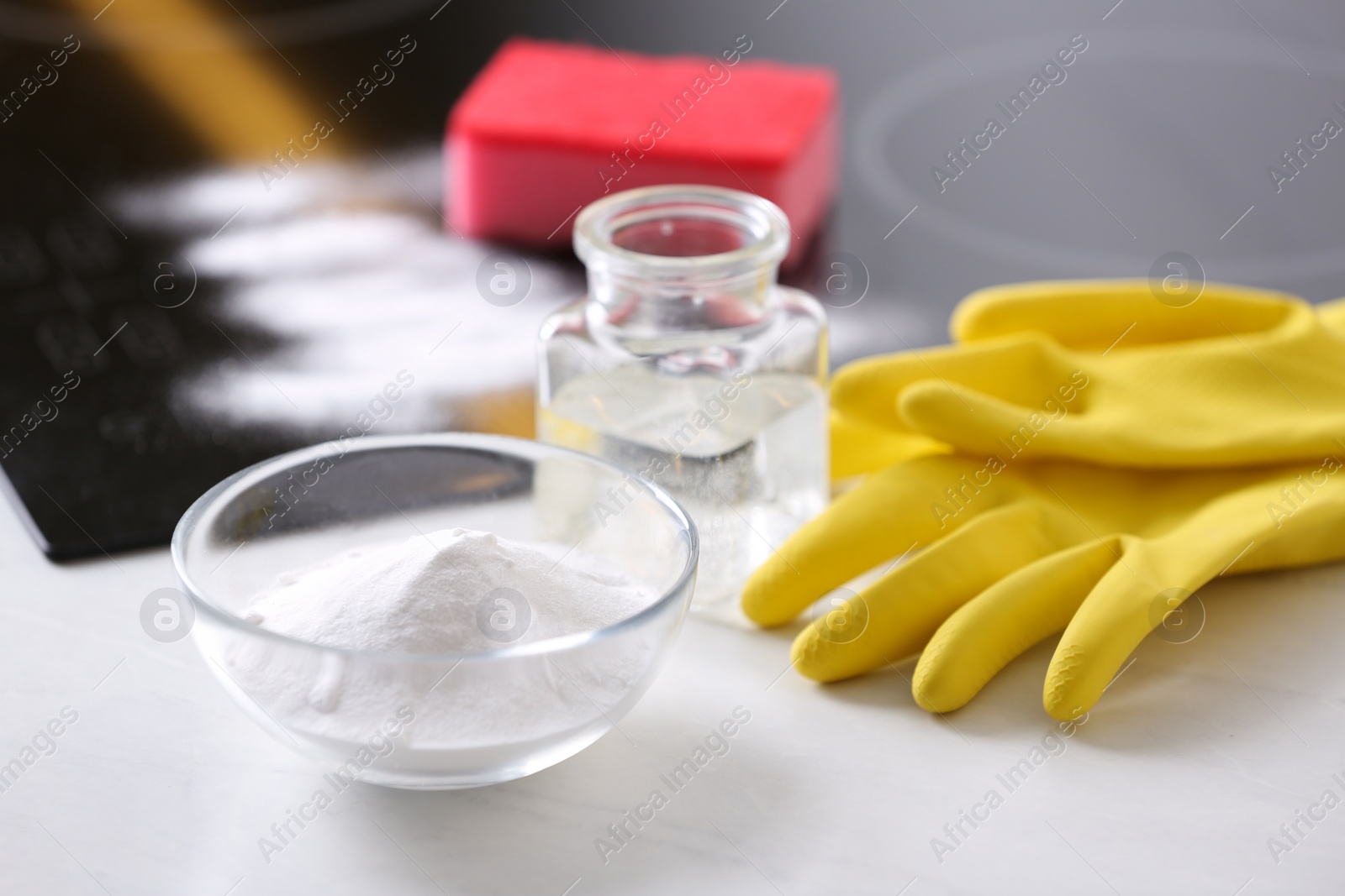 Photo of Baking soda, vinegar and gloves on white table. Eco friendly detergent