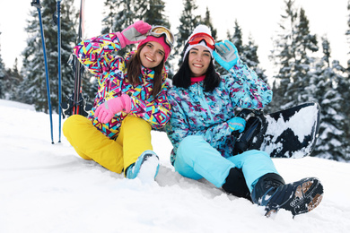 Friends with equipment on snowy hill. Winter vacation