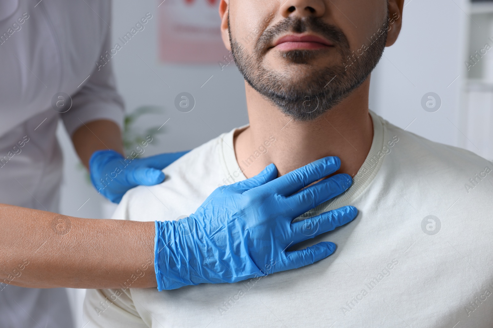 Photo of Endocrinologist examining thyroid gland of patient at hospital, closeup