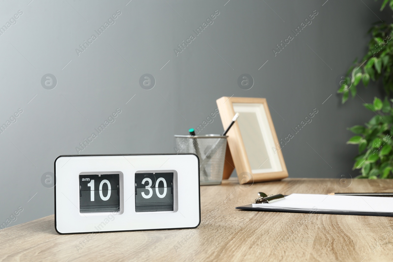 Photo of Stylish flip clock on table in office,  space for text. Time management