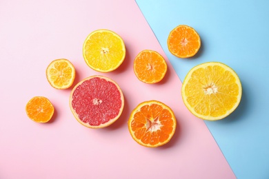 Different citrus fruits on color background, flat lay