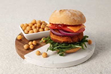 Photo of Tasty vegetarian burger with chickpea cutlet on white table