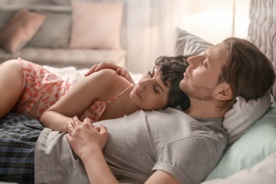 Photo of Young lovely couple sleeping in bed at home