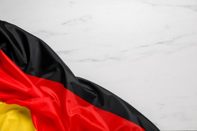 Flag of Germany on white marble background, top view. Space for text