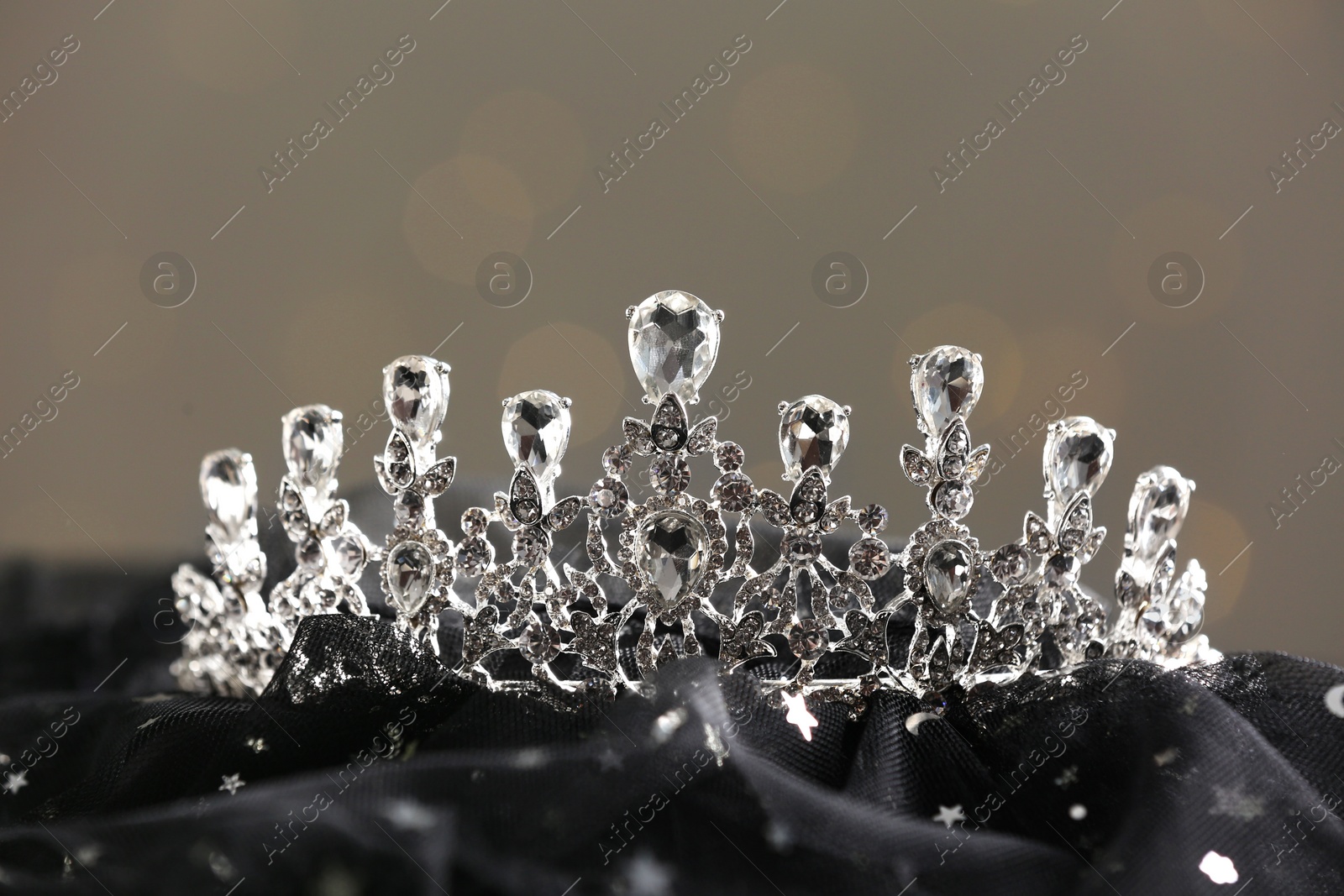 Photo of Beautiful silver tiara with diamonds on dark cloth