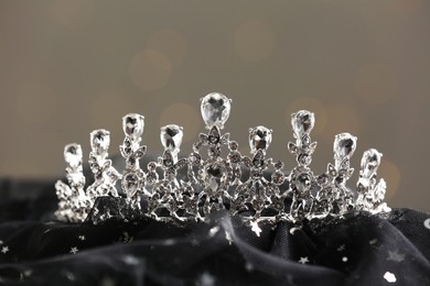 Beautiful silver tiara with diamonds on dark cloth