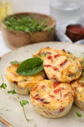 Freshly baked bacon and egg muffins with cheese on table, closeup