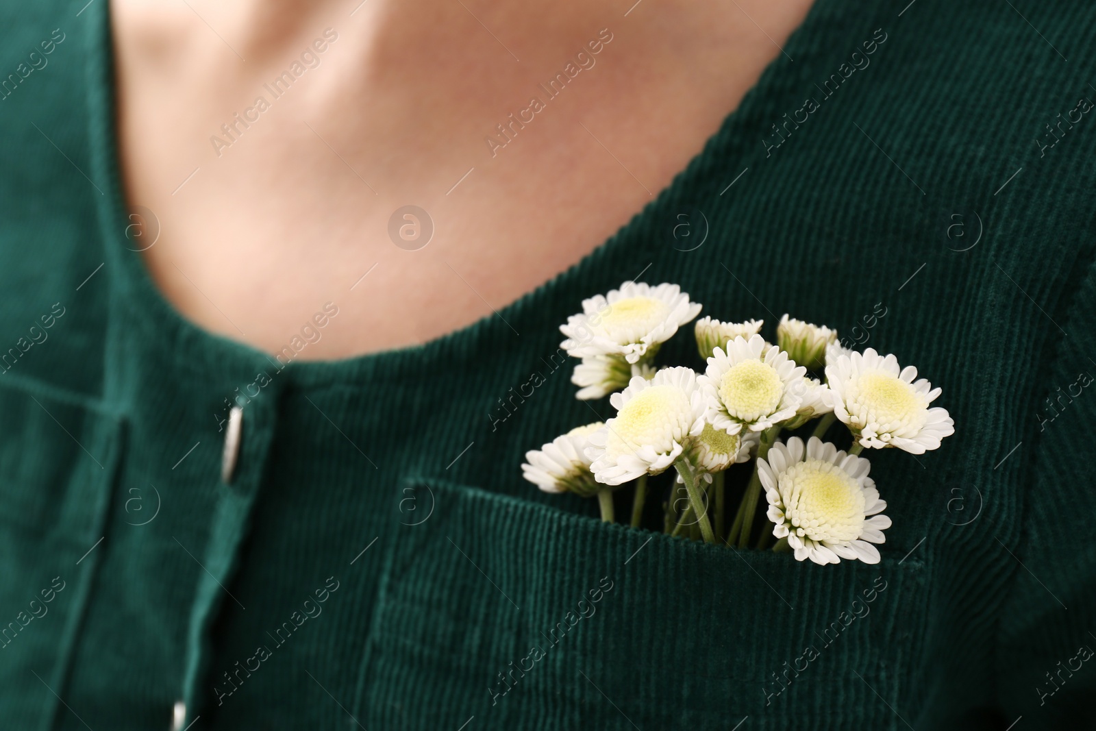 Photo of Woman wearing shirt with flowers in pocket, closeup