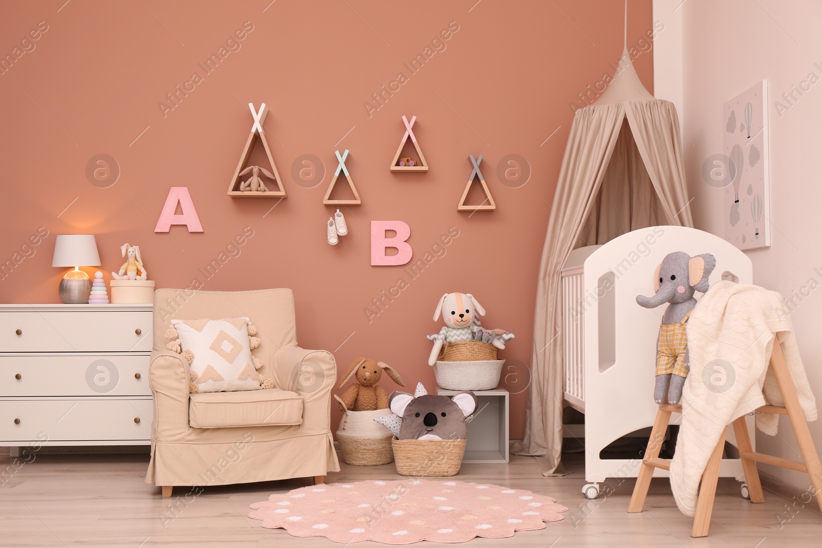 Photo of Baby room interior with stylish furniture and comfortable crib