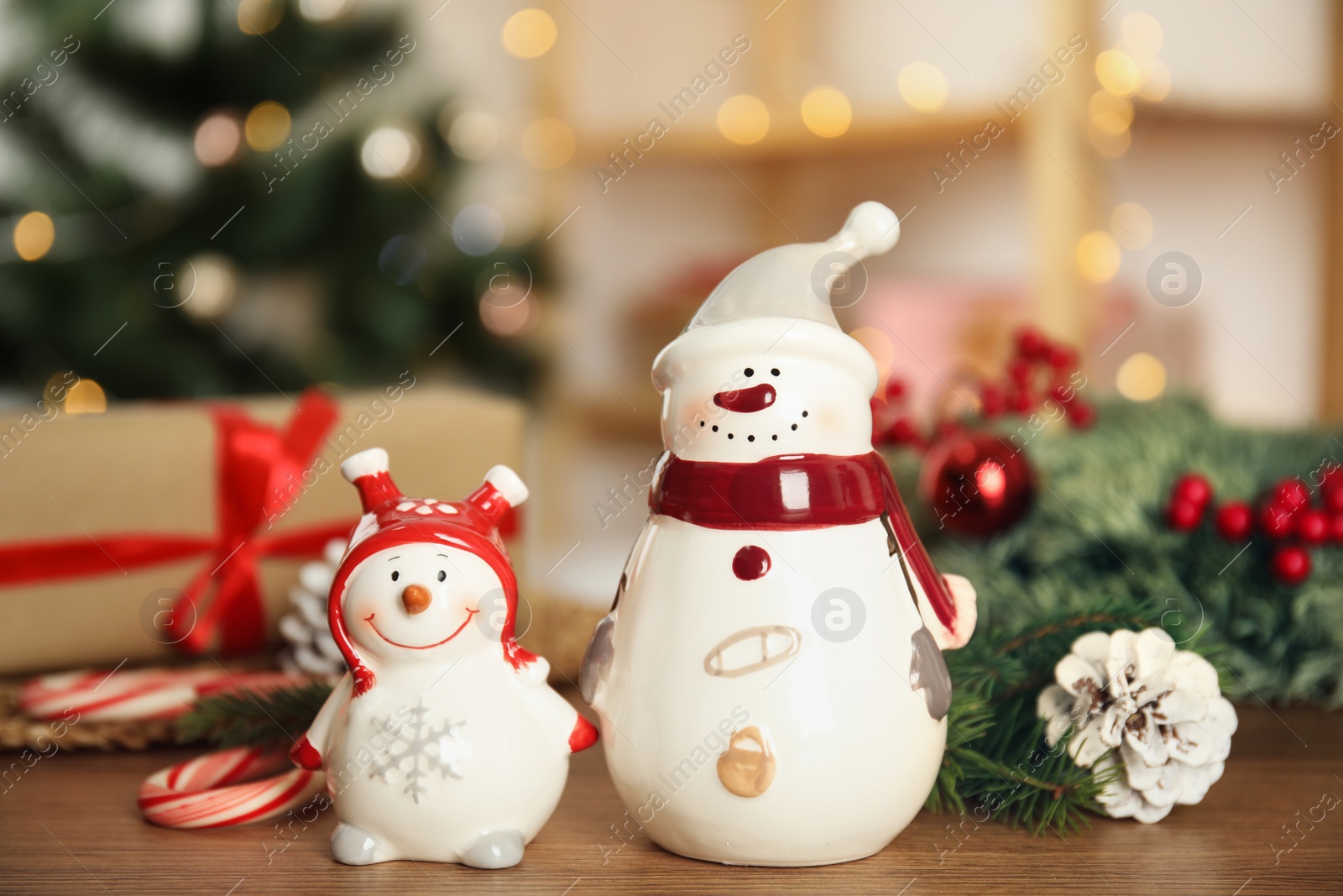 Photo of Christmas composition with decorative snowmen on wooden table