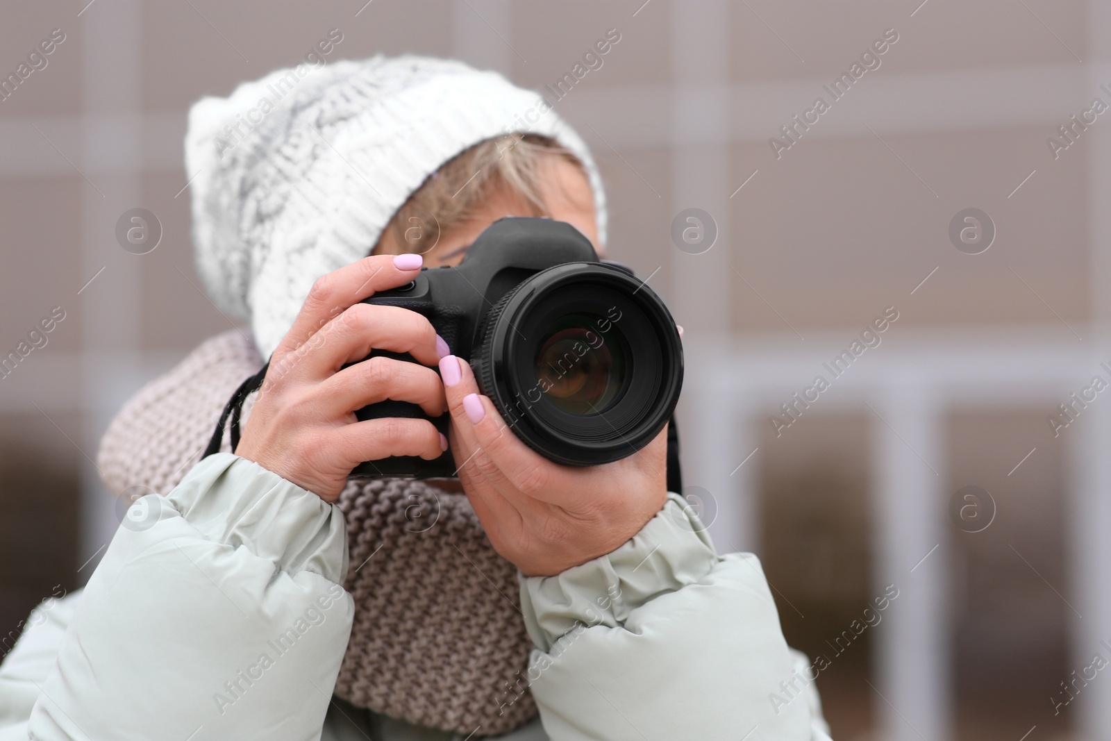 Photo of Photographer taking photo with professional camera outdoors