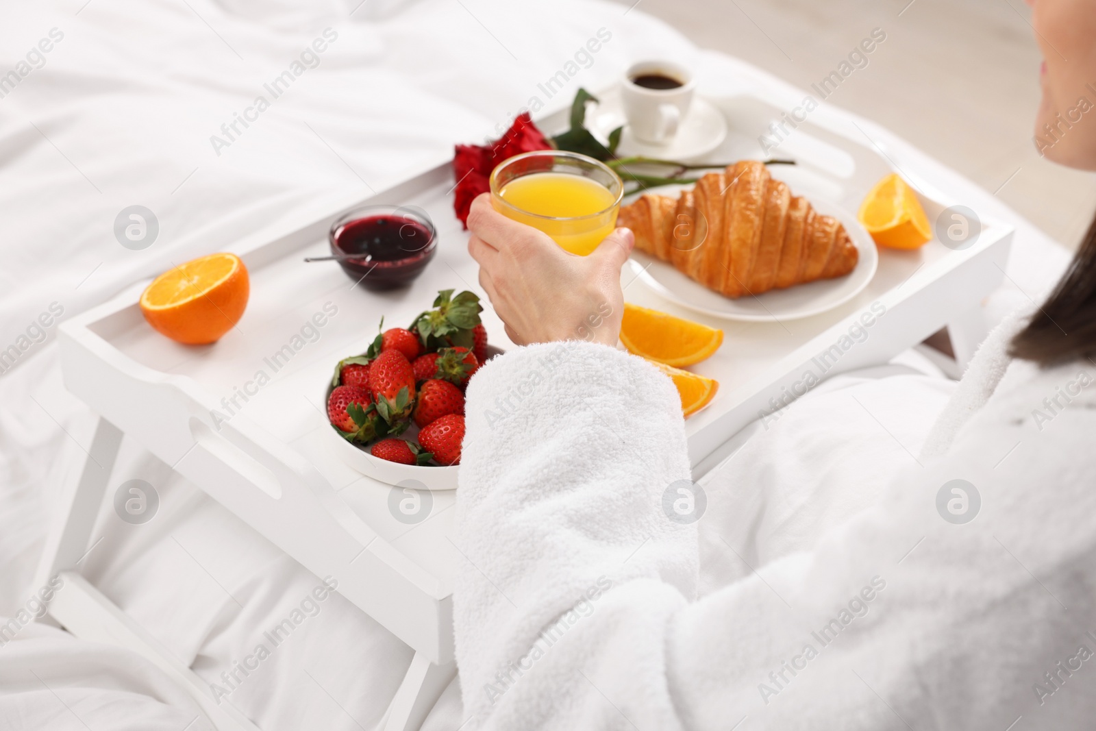 Photo of Woman having breakfast in bed at home, closeup