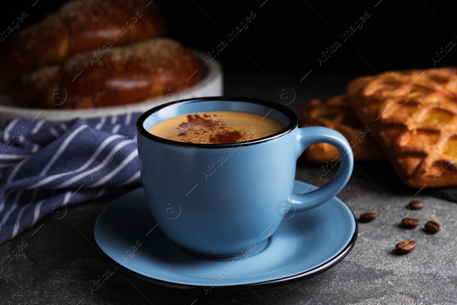 Photo of Delicious coffee and pastries on grey table