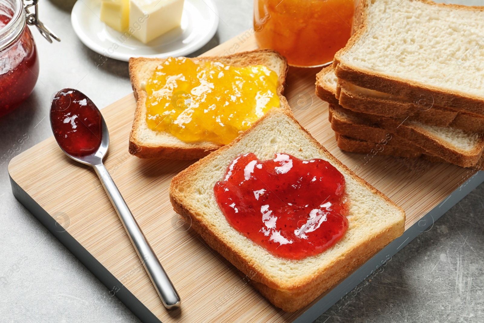 Photo of Toast bread with jams on wooden board