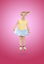 Image of Happy cute girl jumping on color gradient background