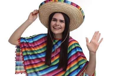 Photo of Young woman in Mexican sombrero hat and poncho waving hello on white background