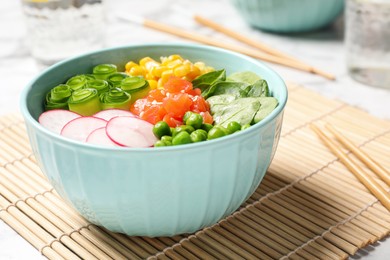 Photo of Delicious salad with salmon and vegetables on table, closeup
