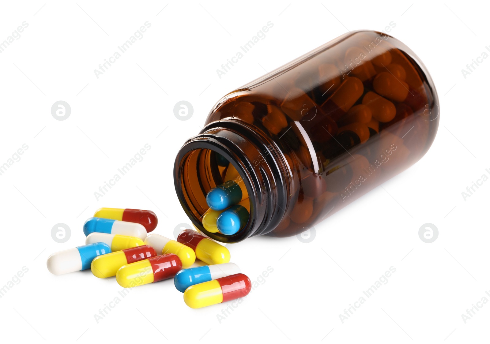 Photo of Scattered antibiotic pills and bottle isolated on white