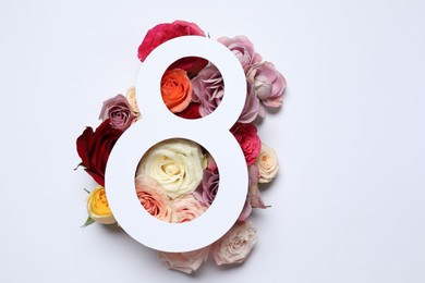 Photo of 8 March greeting card design with roses on white background, top view. Happy International Women's Day