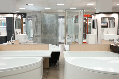 Plumbing department with shower stalls, trays and vanity units in store