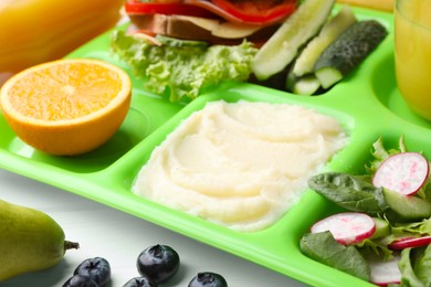 Photo of Serving tray of healthy food on table, closeup. School lunch