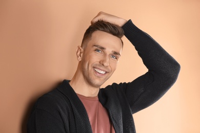 Photo of Portrait of young man with beautiful hair on color background