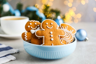 Delicious Christmas cookies in bowl on light table