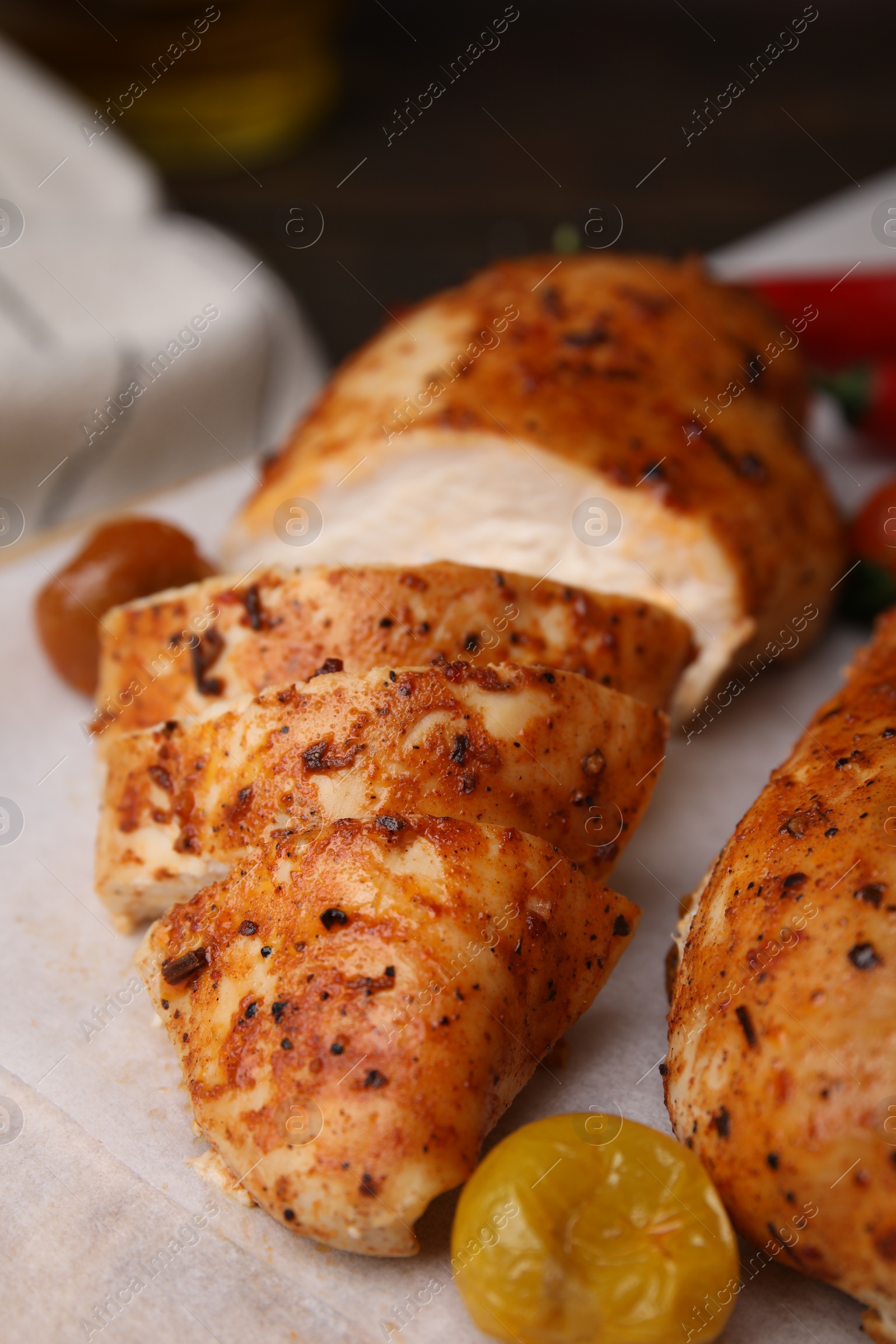 Photo of Baked marinated chicken fillets on table, closeup