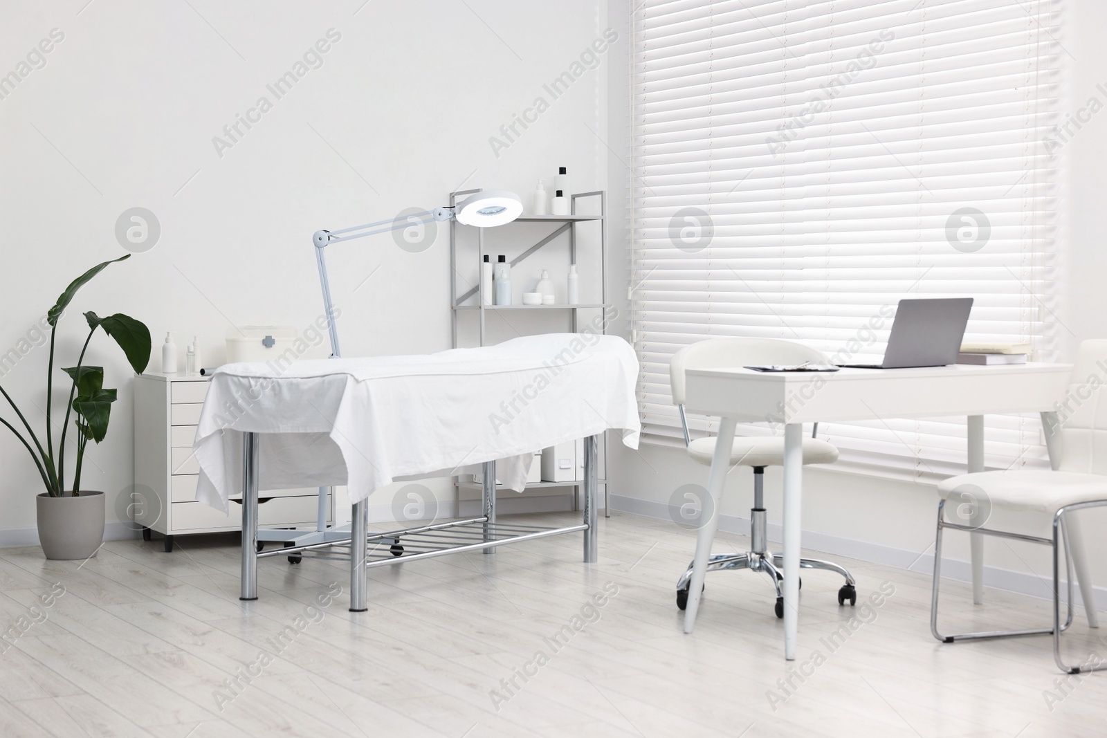 Photo of Modern interior of dermatologist's office with examination table