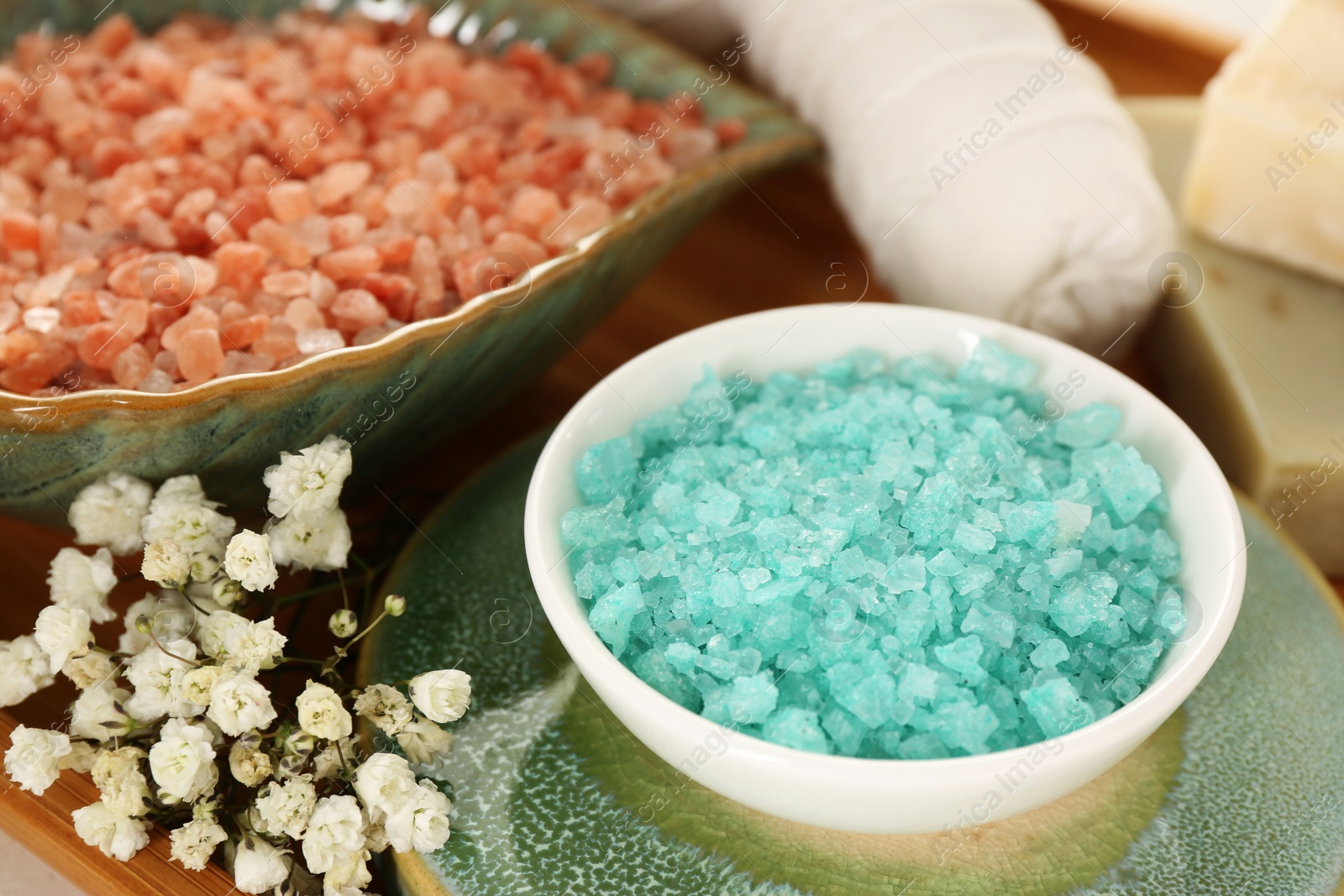 Photo of Aromatic sea salt and beautiful flowers, closeup