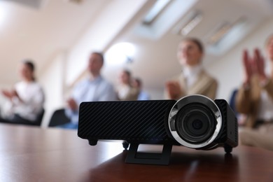 Photo of Modern video projector on table during conference