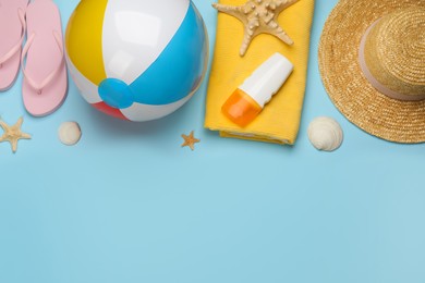 Photo of Flat lay composition with beach ball on light blue background. Space for text