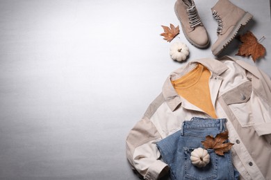 Photo of Fall fashion. Layout of women's outfit on light grey background, top view. Space for text